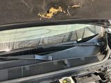a car that has a broken hood and a broken engine