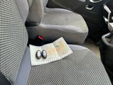 a car seat with a newspaper and a pair of shoes on it
