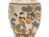 a vase with a painting on it sitting on a table
