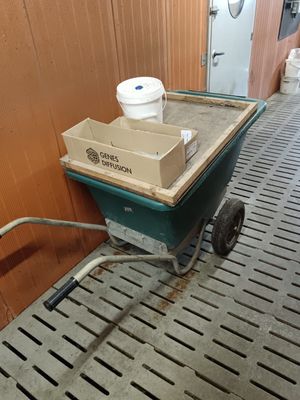 a small cart with a box and a cup on top of it