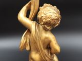 an image of a statue of a child holding a vase