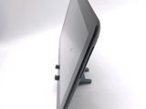 a tablet computer sitting on a stand on a white surface