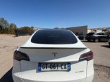 the rear end of a white tesla model s parked in a parking lot