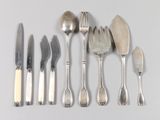 a lot of silver spoons and forks on the table