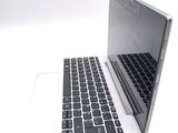 a white laptop with a black keyboard on a white surface