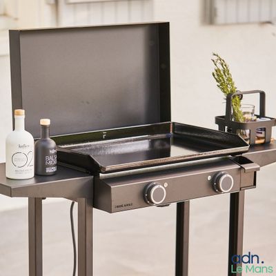 an image of a grill with a bottle of alcohol on it