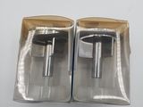 pair of two silver metal handles in a box on a white surface