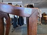 a wooden chair with a label on it in a room