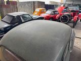 many old cars parked in a lot next to each other