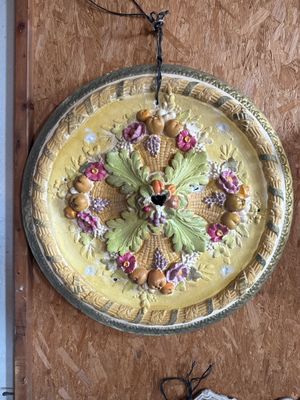 a clock that is hanging on the wall next to other things