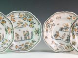 three plates with different designs on them sitting next to each other