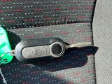a key in the seat of a car with a keychain attached to it