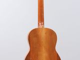 an acoustic guitar with a wooden body on a white background