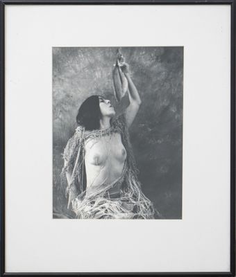 black and white photograph of a woman holding a cigarette in her hand