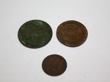 three different types of coins are shown on a white surface