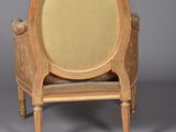 an image of a wooden chair with a beige upholstered seat