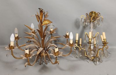 two chandeliers and a candle holder on a table