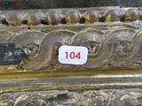 a close up of a gold vase with a number on it