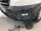 the front end of a white truck parked on the side of the road