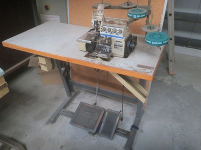 a sewing machine sitting on a workbench in a garage