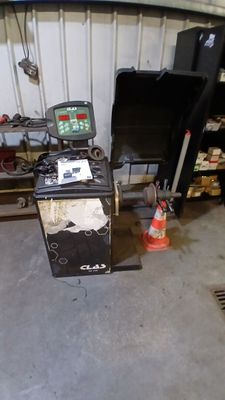 an image of a garage with a lot of tools on the floor