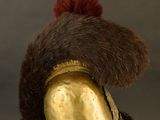 an old helmet with a fur on top of it sitting on a stand