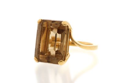 a close up of a gold ring with a smoky quartz stone