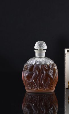 a bottle of liquor sitting on a table next to a box of cigarettes