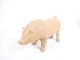 figurine of a pig on a white surface with a white background