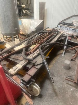 a pile of tools sitting on the floor in the garage