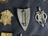several different types of badges are displayed on a black surface