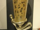 a gold vase that is sitting on a table