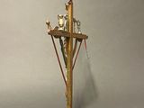 a statue of a cross with a bird on it
