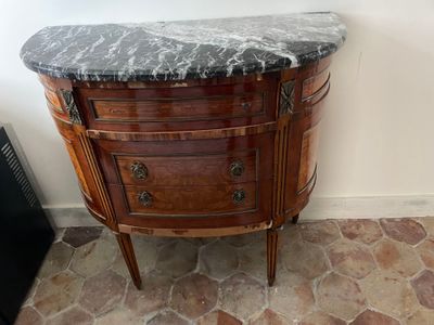 a marble top cabinet in the corner of a room