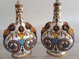 two vases that are sitting on a glass table