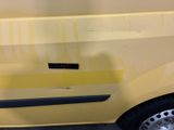 a yellow car with a sticker on the side of it
