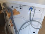 an image of a washing machine with a hose attached to it