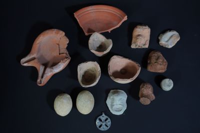 several pieces of pottery are arranged on a black surface
