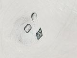 a close up of a metal object on a white surface