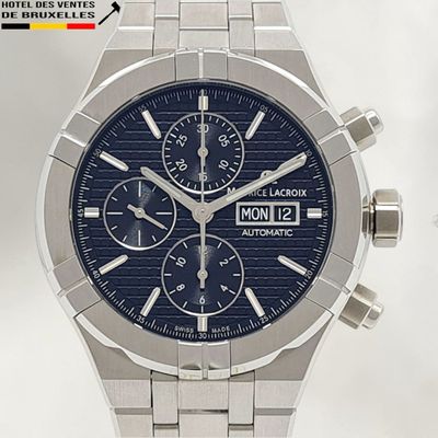 a close up of a watch with a blue face
