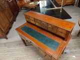 a wooden table with two drawers on top of it