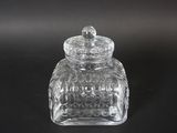 clear glass jar with a lid on a black surface