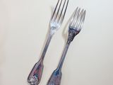 two forks and two spoons on the table