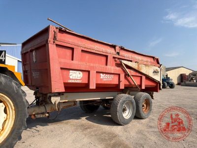 a red dump truck that is parked in a lot