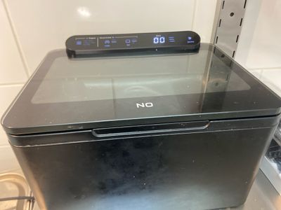 an image of a microwave with a digital clock on top of it