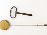 two antique keys and a stick on a white surface