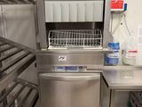 a stainless steel dishwasher in a commercial kitchen