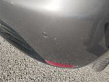 a close up of a car ' s bumper with a hole in it