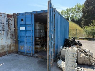 a blue shipping container sitting in the middle of a parking lot