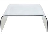 a clear glass coffee table with black metal legs